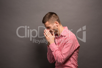 Man covering eyes his face