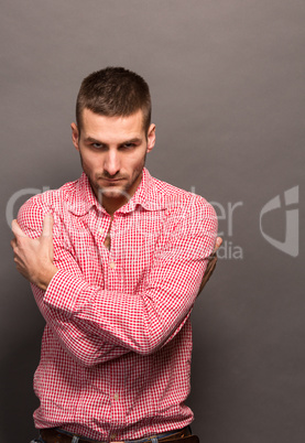 Man hugging himself in studio