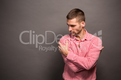 Man hugging himself in studio