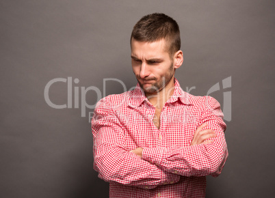 Man posing with crossed arms in studio