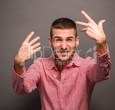 Young man with his hands in air