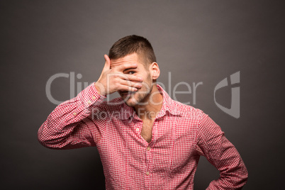 Man covering eyes his face