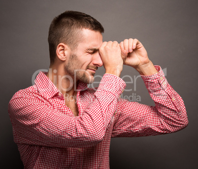 Man making binocular or tube from hands