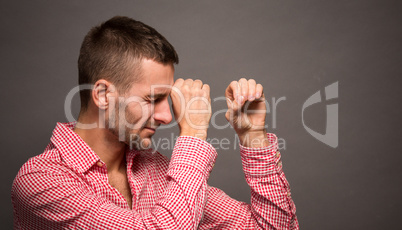 Man making binocular or tube from hands