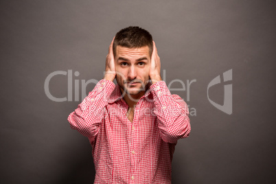 Man covering his ears