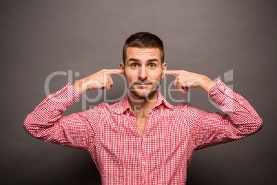 Man covering his ears