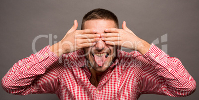 Man covering eyes with hands