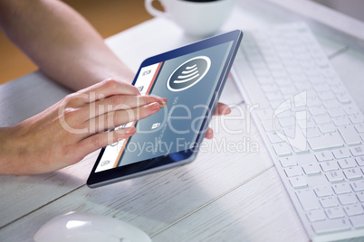 Composite image of woman using tablet at work
