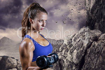 Composite image of side view of fit woman lifting dumbbell