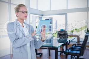 Composite image of businesswoman using digital tablet