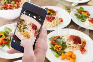 Composite image of woman using her mobile phone