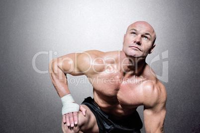 Composite image of bodybuilder exercising against black backgrou