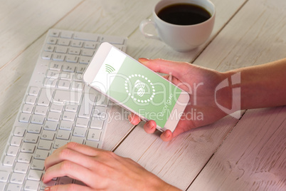 Composite image of woman using smartphone at work