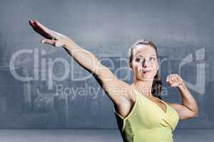 Composite image of beautiful confident athlete stretching hands