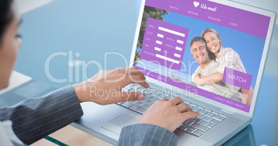 Composite image of businesswoman using laptop