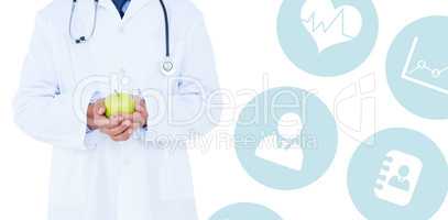 Composite image of male doctor holding green apple