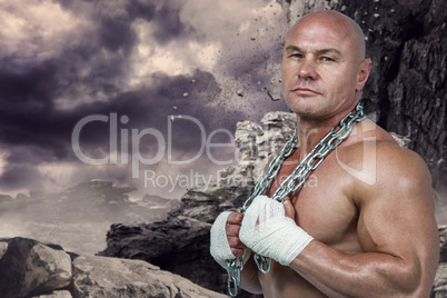 Composite image of portrait of confident bodybuilder holding cha