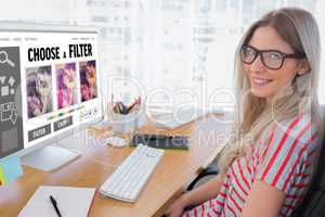 Composite image of attractive photo editor working on computer