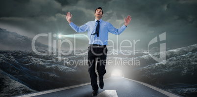 Composite image of happy businessman running with hands up