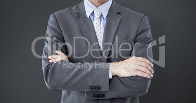 Composite image of midsection of businessman standing arms cross