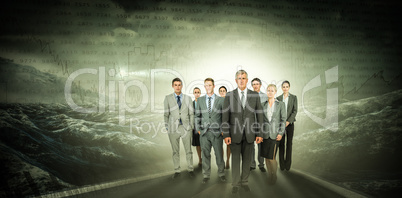 Composite image of smiling business team looking at camera