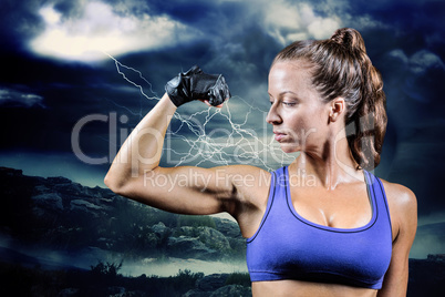 Composite image of confident woman flexing muscles