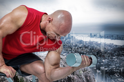 Composite image of bald man exercising with dumbbells while sitt