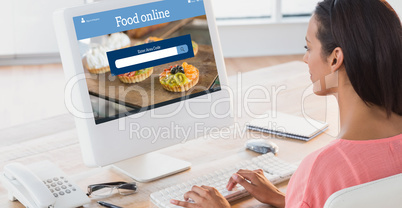 Composite image of businesswoman using computer at desk in creat