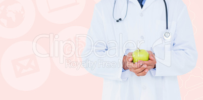 Composite image of male doctor holding green apple