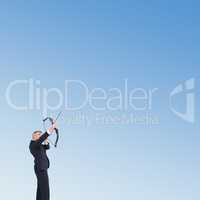 Composite image of businessman shooting bow and arrow