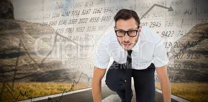 Composite image of geeky young businessman ready to race