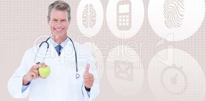 Composite image of smiling male doctor holding green apple while