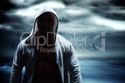 Composite image of portrait of confident man in hood