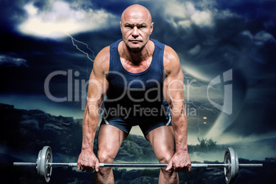 Composite image of portrait of muscular man exercising with cros