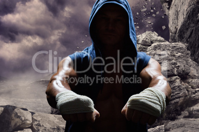 Composite image of athlete in hood with bandage on hand
