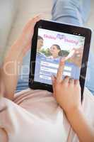 Composite image of girl using her tablet on the couch