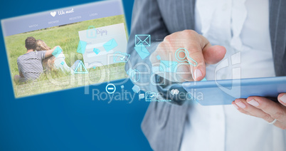 Composite image of  businesswoman using her tablet