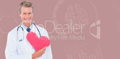 Composite image of smiling male doctor holding heart shape card