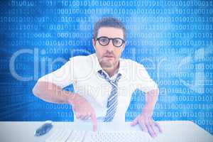 Composite image of businessman working at his desk