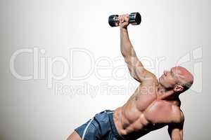 Composite image of man exercising with dumbbells