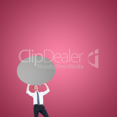 Composite image of businessman holding a speech bubble