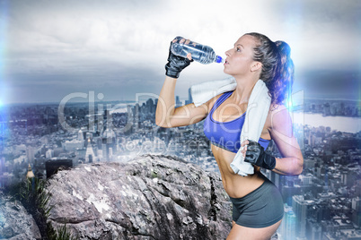 Composite image of fit woman drinking water