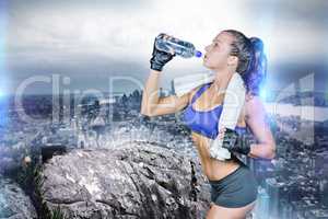Composite image of fit woman drinking water