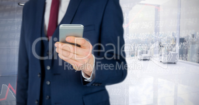 Composite image of  businessman using mobile phone