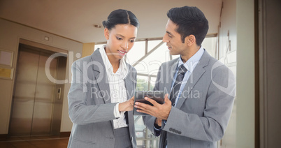 Composite image of business people discussing over digital table