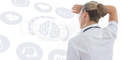 Composite image of wear view of confident female doctor looking