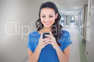 Composite image of pretty brunette sending a text