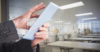 Composite image of businessman scrolling on his digital tablet