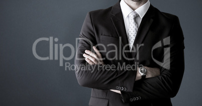 Composite image of smiling businessman posing with arms crossed