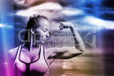 Composite image of fit woman flexing muscles